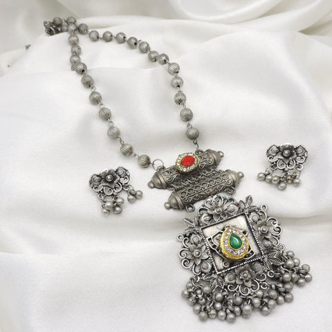 Oxidized floral green red stone pendant necklace set with matching earrings and hanging bead detailing by joyrias