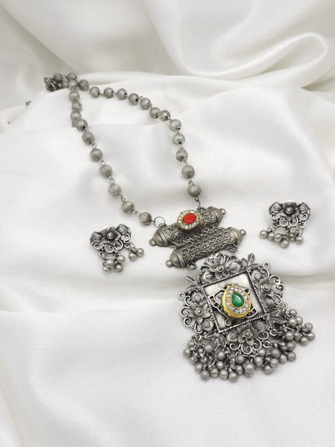 Oxidized floral green red stone pendant necklace set with matching earrings and hanging bead detailing by joyrias