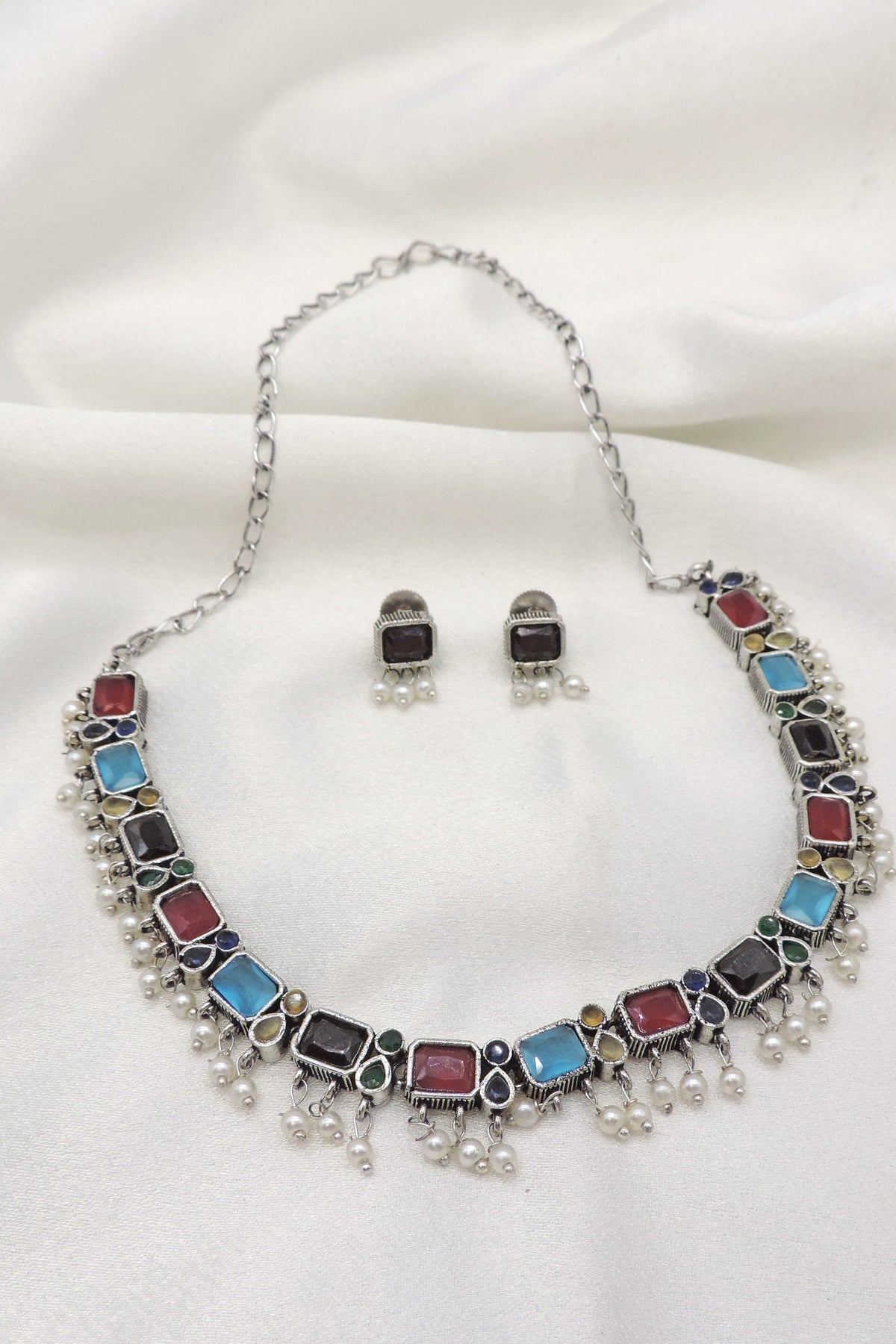 Oxidized dual-tone multicolor rectangular stone necklace set with matching earrings and pearl detailing by joyrias