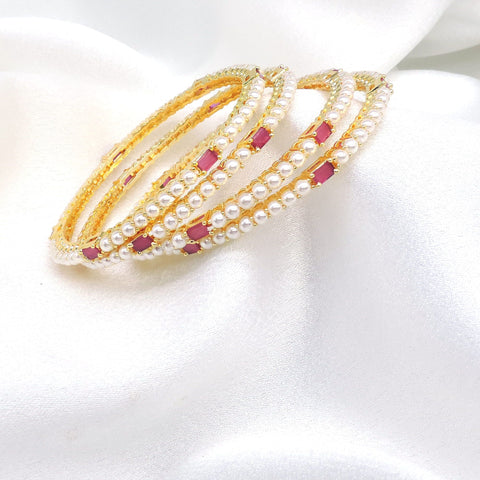Gold-toned pink stone pearl AD bangle set with delicate pearl detailing by joyrias