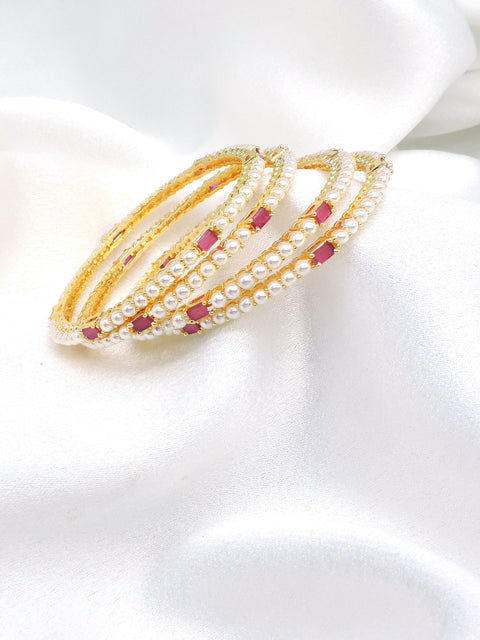 Gold-toned pink stone pearl AD bangle set with delicate pearl detailing by joyrias