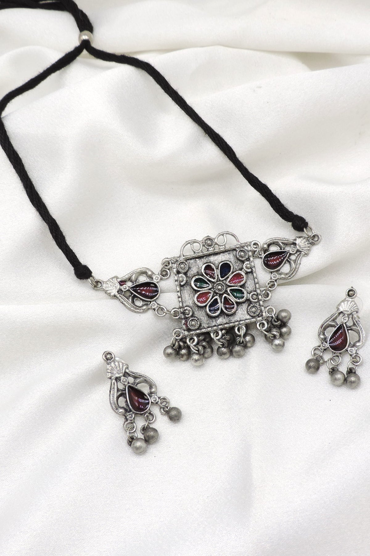 Oxidized multicolor floral necklace set with maroon, green and blue stones and matching earrings by joyrias
