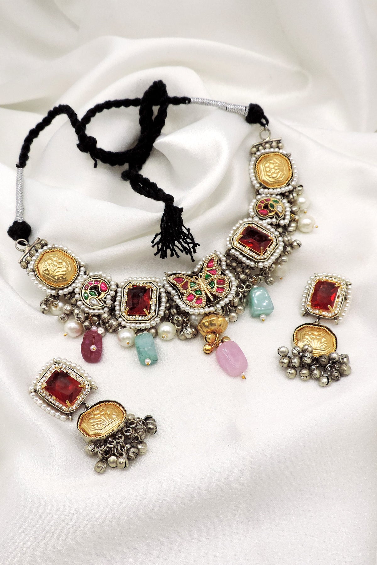 Oxidized multicolor kundan necklace set with pearl detailing and matching earrings by Joyrias