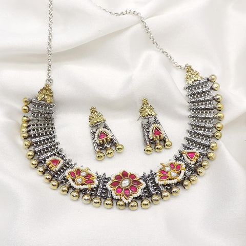 Oxidized dual-tone floral necklace set with pink stone accents, pearl detailing, and matching earrings by joyrias