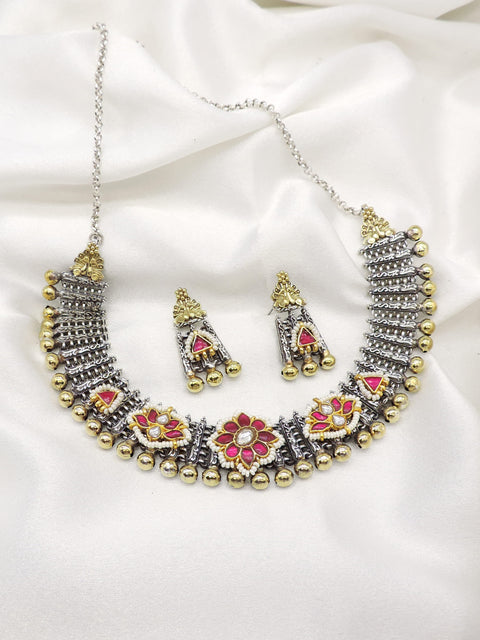 Oxidized dual-tone floral necklace set with pink stone accents, pearl detailing, and matching earrings by joyrias