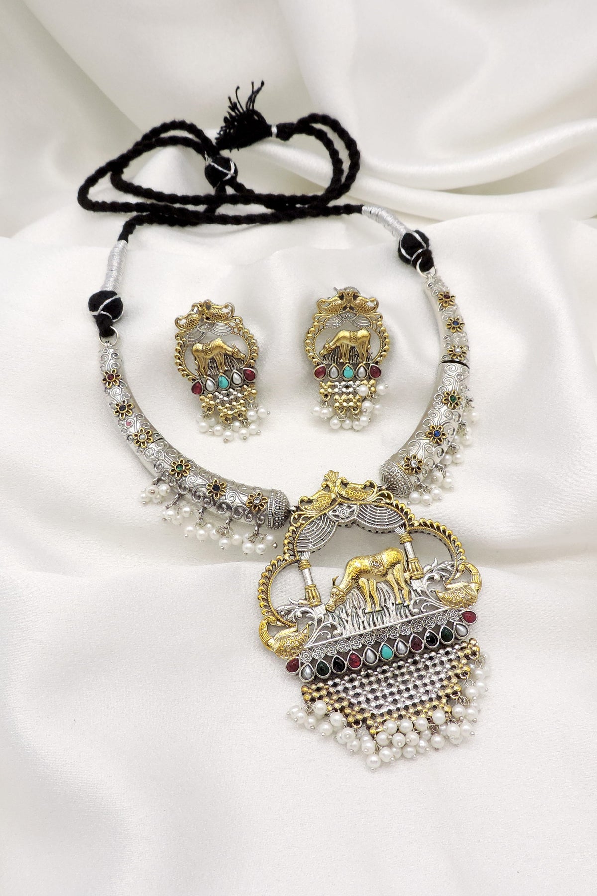 Oxidized dual-tone elephant pearl hasli necklace set with colorful stones and matching earrings by joyrias