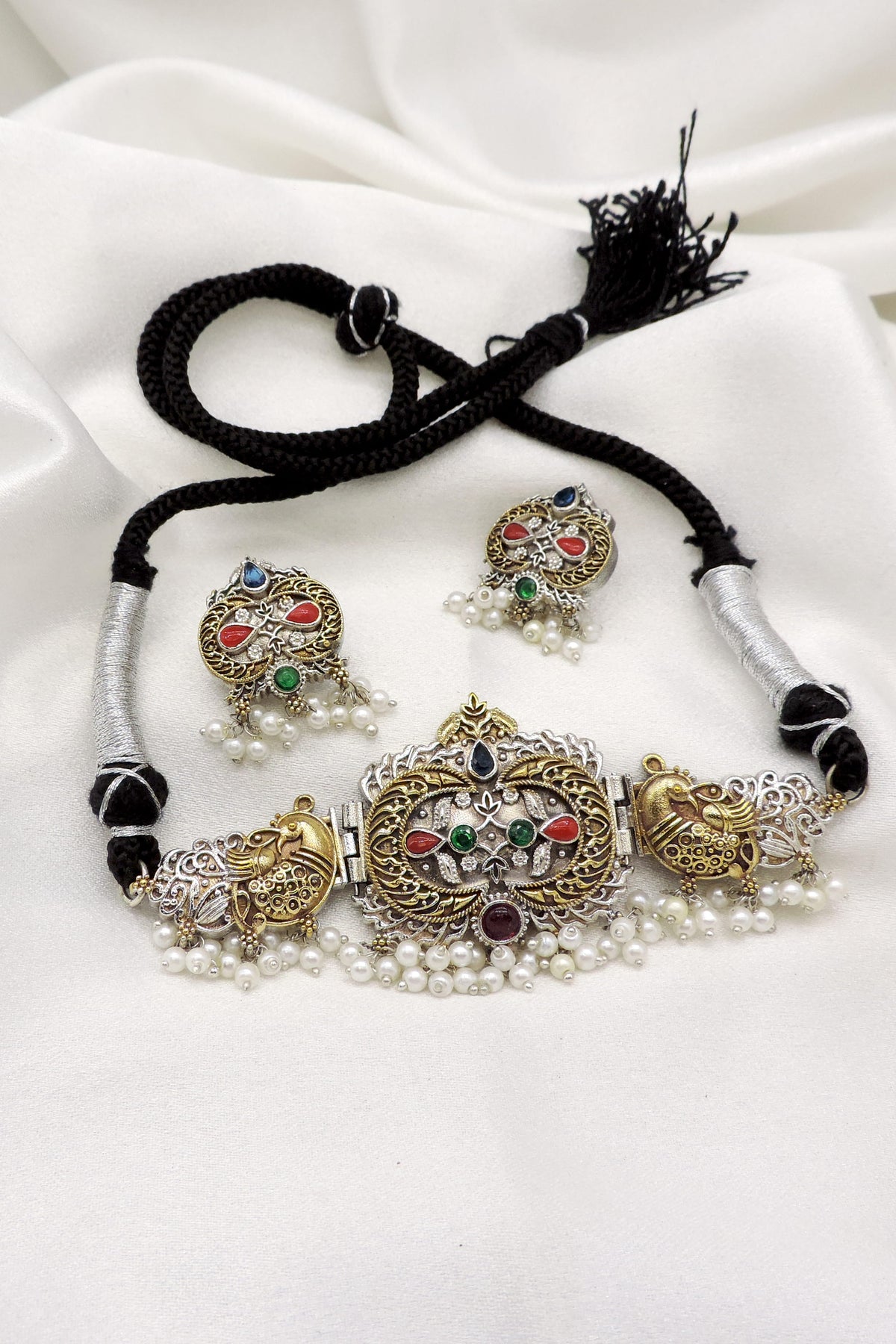 Oxidized dual-tone peacock pearl choker set with colorful stone detailing and matching earrings by joyrias