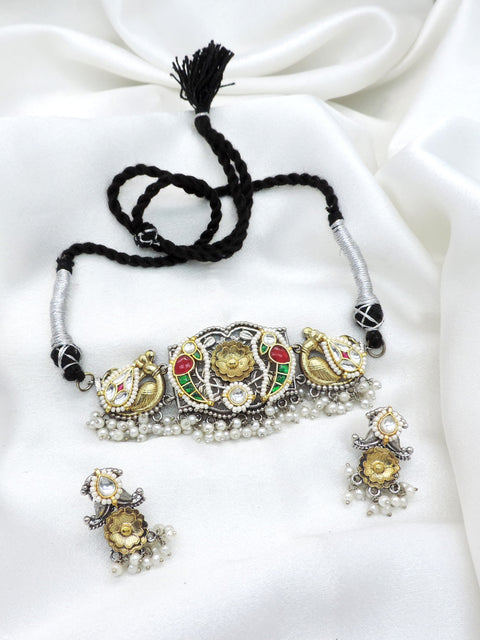 Oxidized dual-tone peacock floral kundan choker set with colorful stones and pearl detailing by joyrias