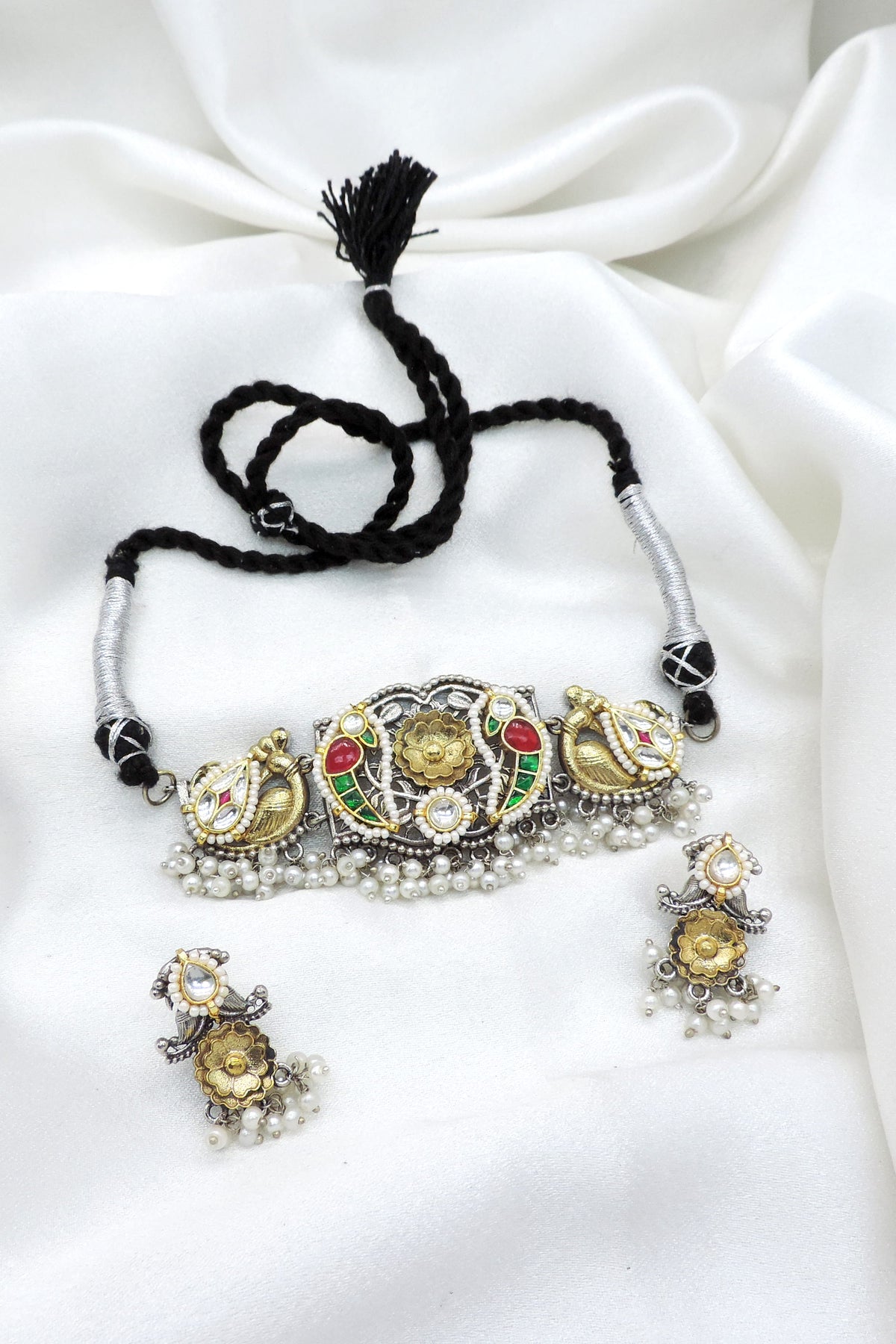 Oxidized dual-tone peacock floral kundan choker set with colorful stones and pearl detailing by joyrias