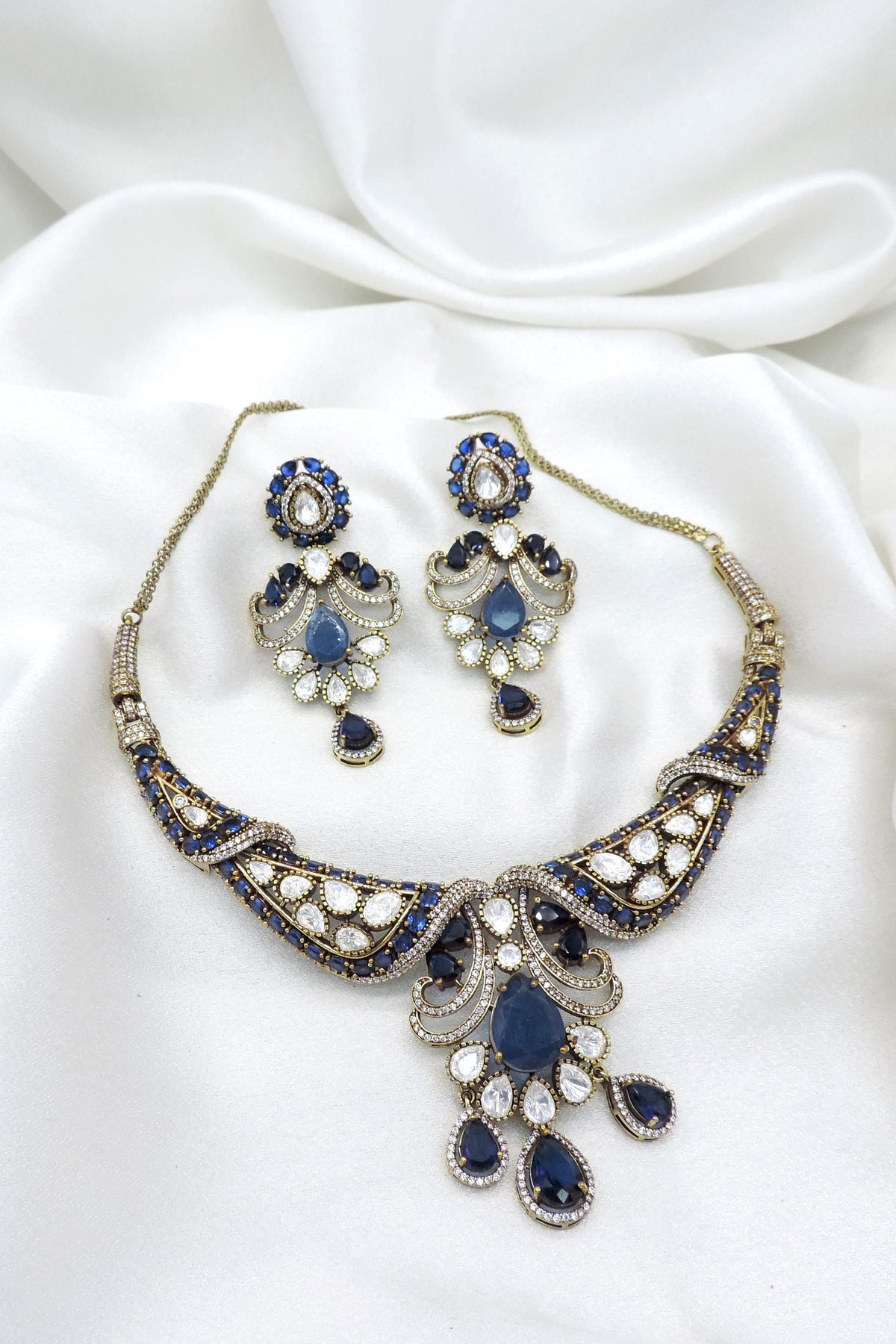 Gold-plated royal blue kundan choker set with matching earrings by joyrias