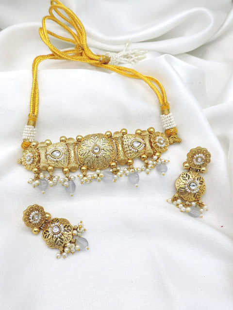 Gold tone pearl kundan choker set with matching earrings