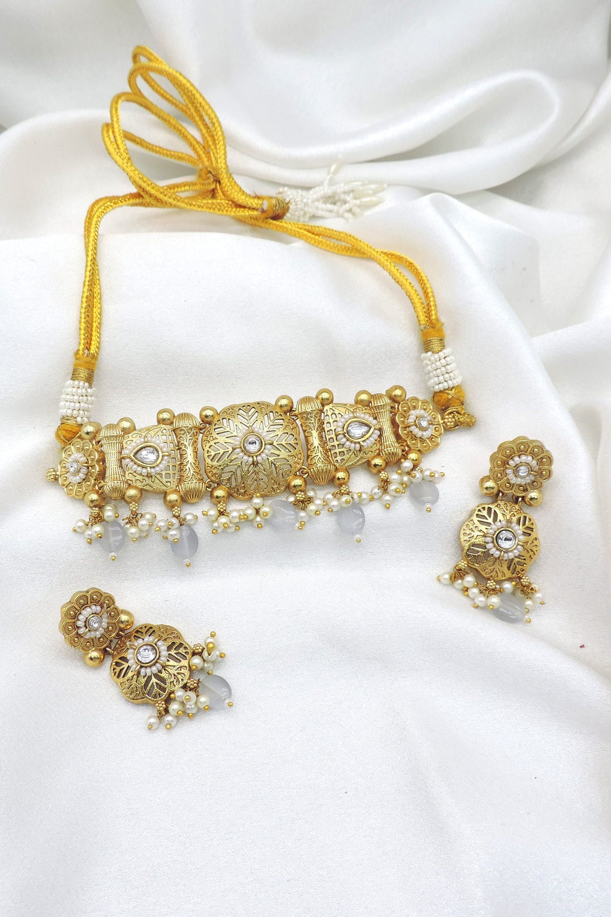 Gold tone pearl kundan choker set with matching earrings