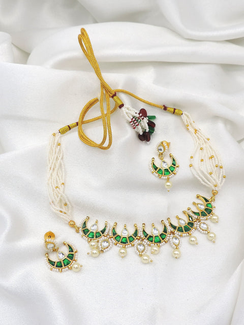 Green kundan crescent pearl choker set with matching earrings by Joyrias