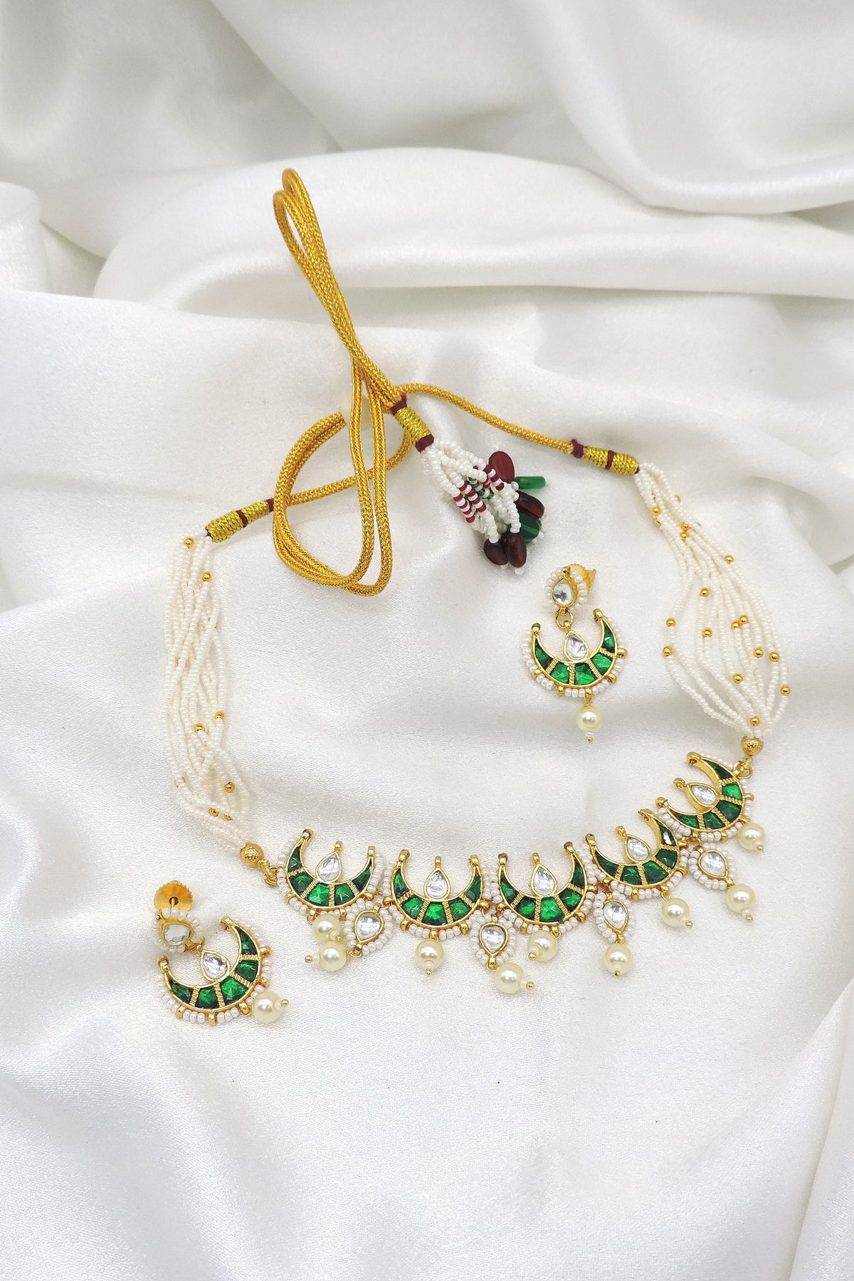 Green kundan crescent pearl choker set with matching earrings by Joyrias