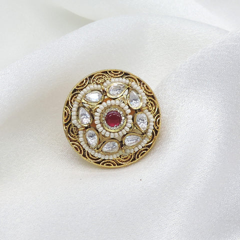 Temple ornate kundan polki ring with red center stone and pearl detailing by joyrias