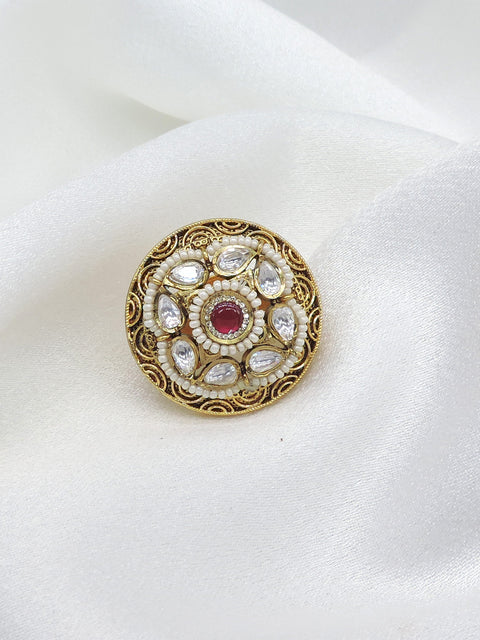 Temple ornate kundan polki ring with red center stone and pearl detailing by joyrias