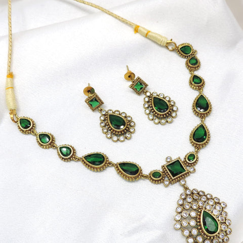 Emerald stone necklace set with matching earrings by Joyrias