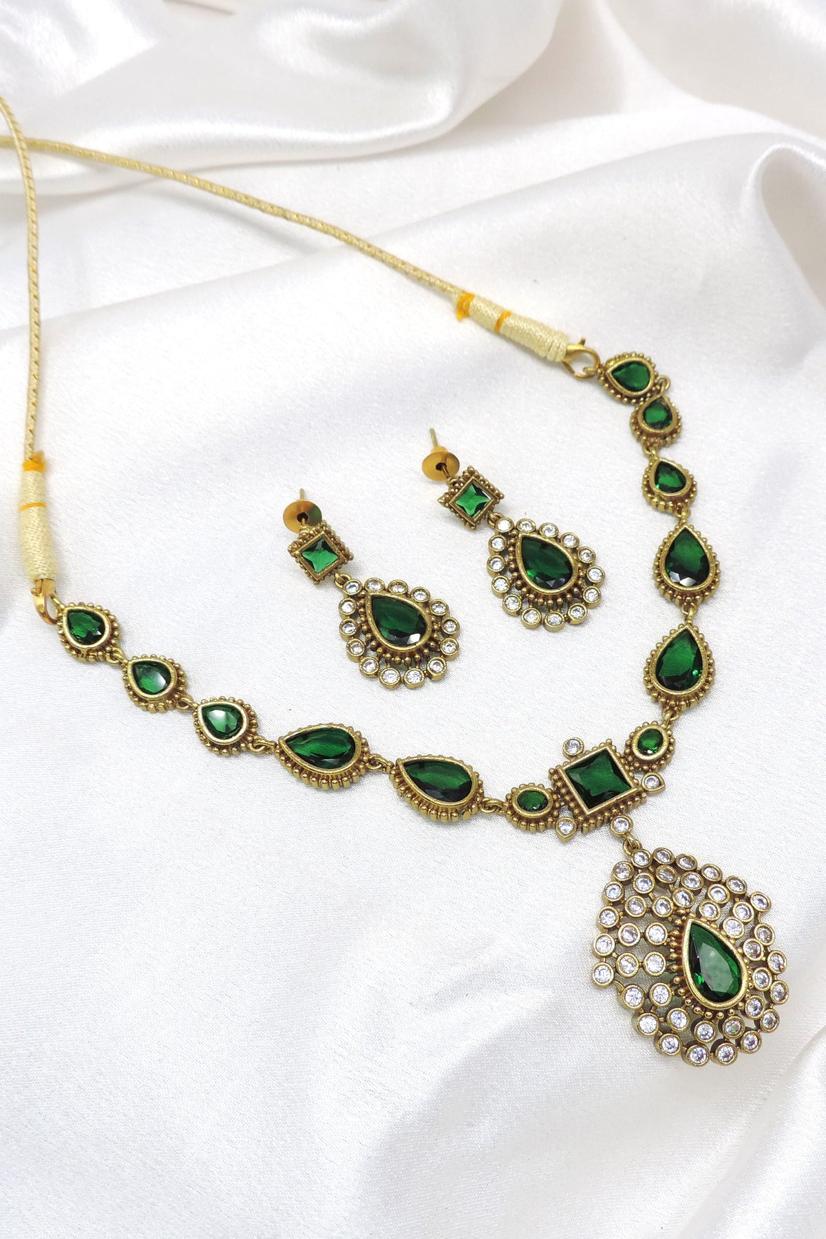 Emerald stone necklace set with matching earrings by Joyrias