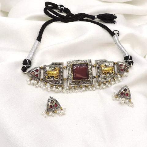 Oxidized dual-tone elephant pearl choker set with maroon stone detailing and matching earrings by joyrias