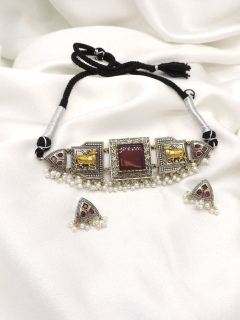 Oxidized dual-tone elephant pearl choker set with maroon stone detailing and matching earrings by joyrias