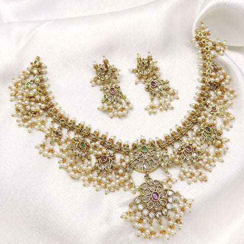 Traditional kundan pearl floral necklace set with matching earrings by joyrias
