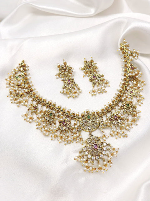 Traditional kundan pearl floral necklace set with matching earrings by joyrias
