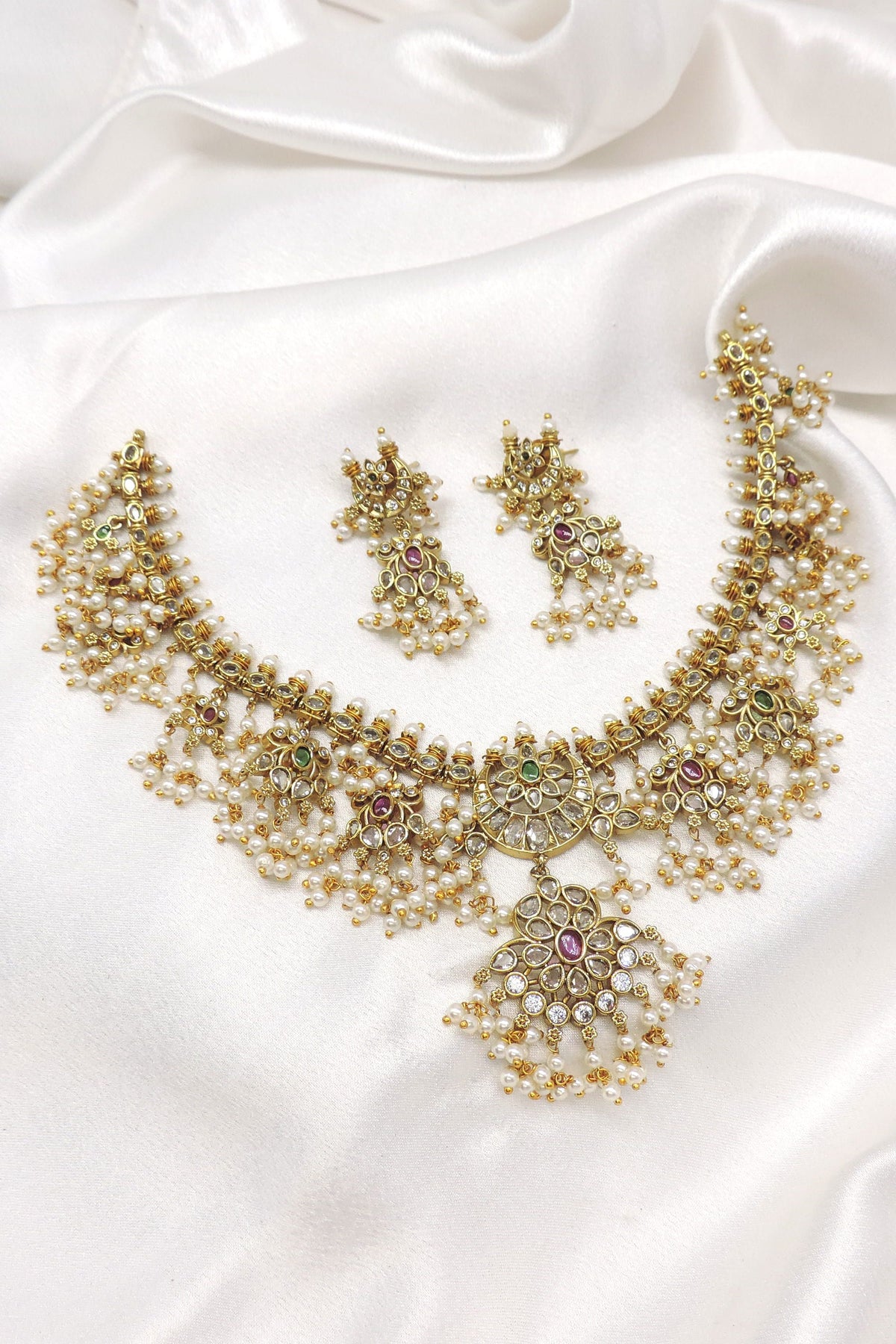 Traditional kundan pearl floral necklace set with matching earrings by joyrias