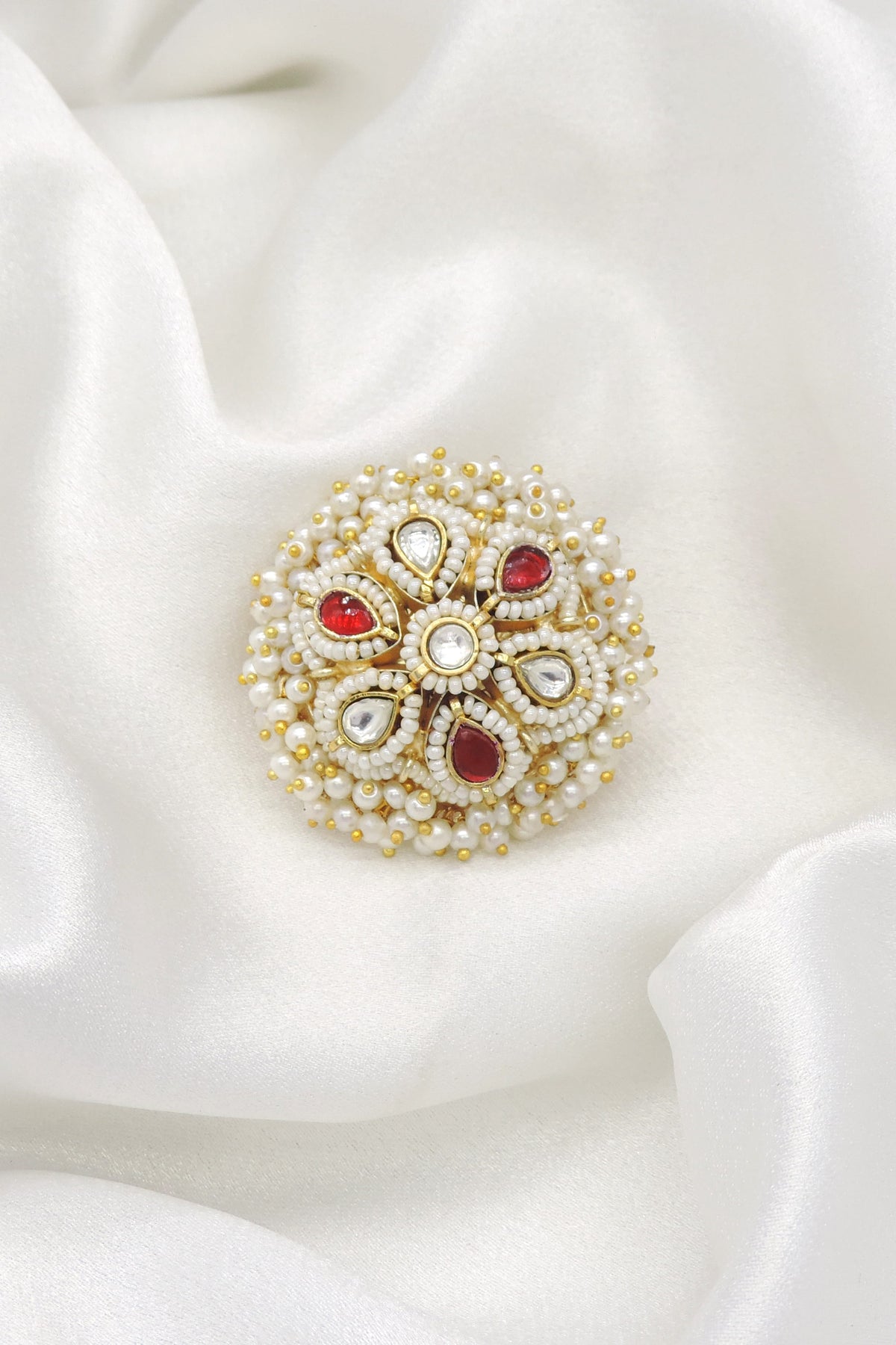 Gold-toned pearl kundan floral ring with red accents by joyrias