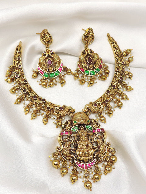Temple gold-toned Lakshmi peacock multicolor necklace set with matching earrings and pearl detailing by joyrias