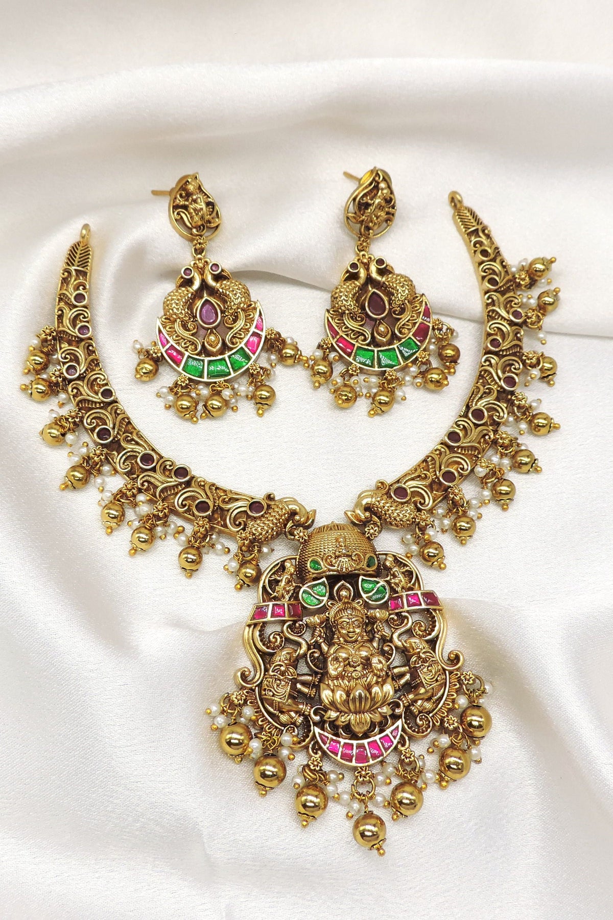 Temple gold-toned Lakshmi peacock multicolor necklace set with matching earrings and pearl detailing by joyrias