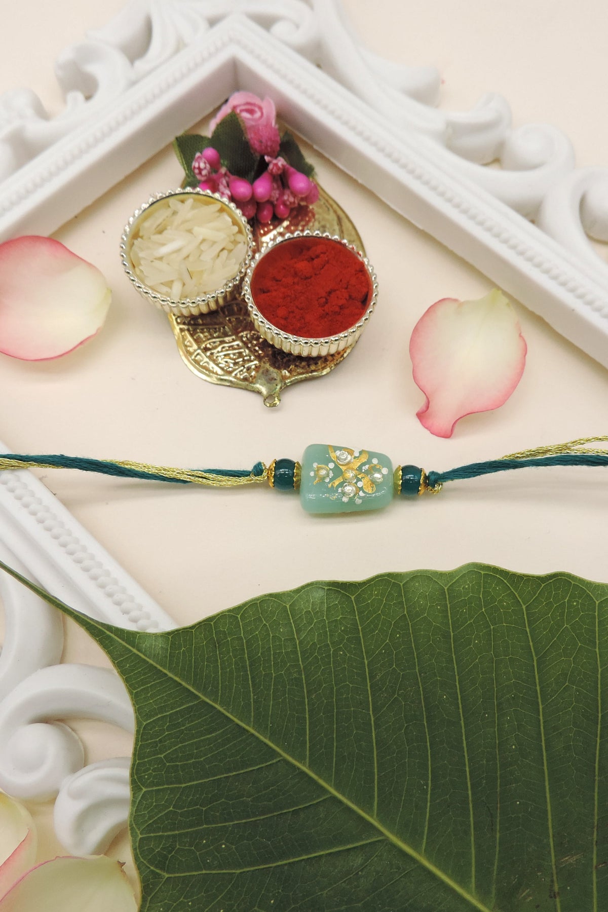 Handcrafted Orange Bead Rakhi with Crystal Floral Design