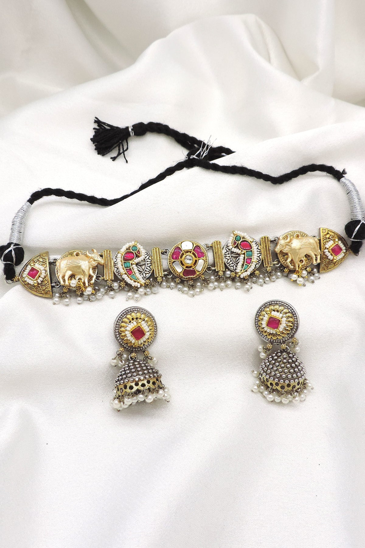 Oxidized dual-tone elephant Meenakari choker set with colorful stones, pearl detailing and matching jhumka earrings by joyrias
