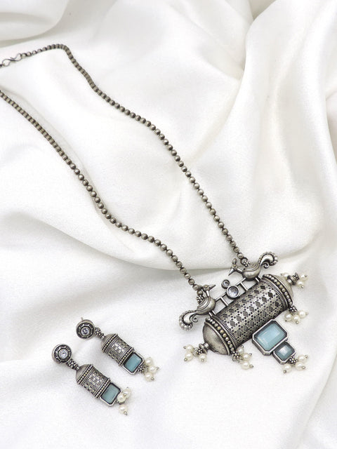 Oxidized peacock carved pendant necklace set with pearl detailing and matching earrings by joyrias