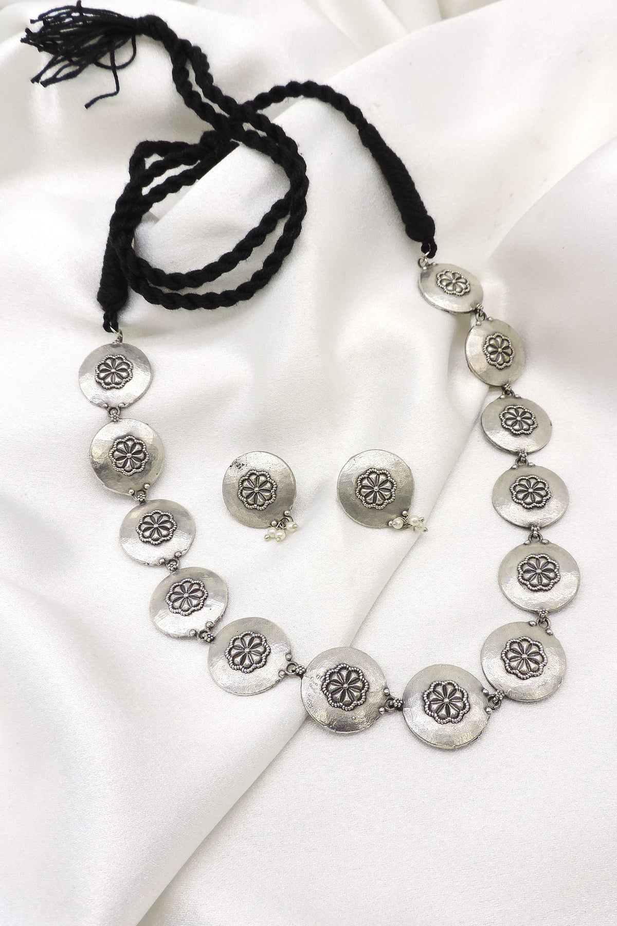 Oxidized silver floral coin choker set with pearl detailing and matching earrings by joyrias