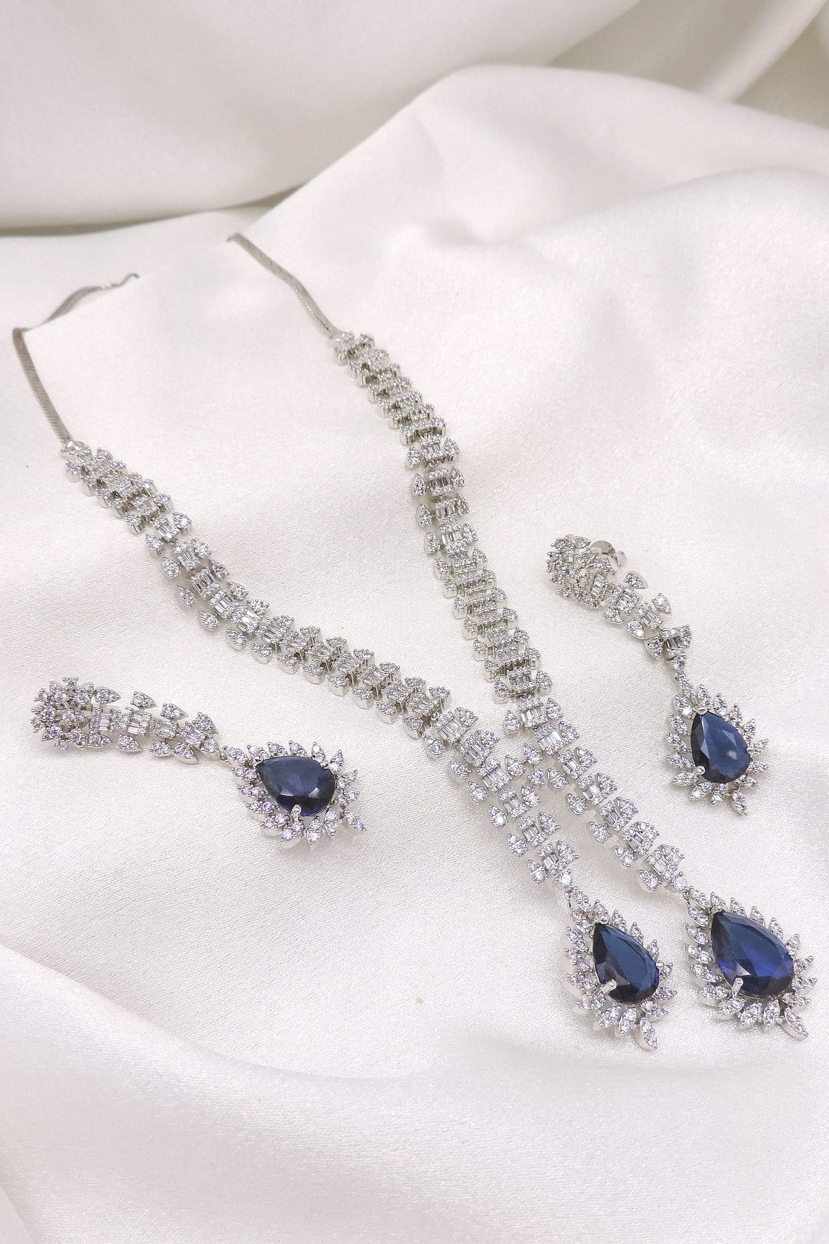 Silver-toned blue sapphire CZ necklace set with matching earrings by joyrias