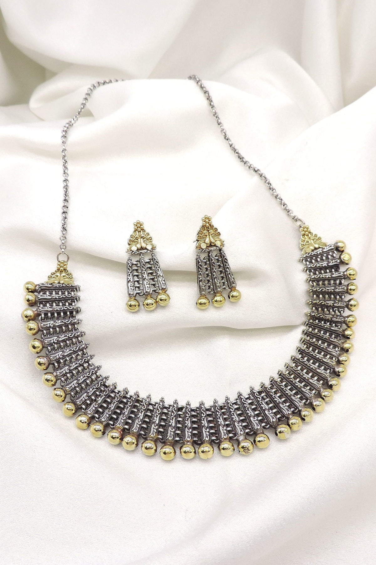Oxidized dual-tone layered bead choker set with intricate silver detailing and matching earrings by joyrias