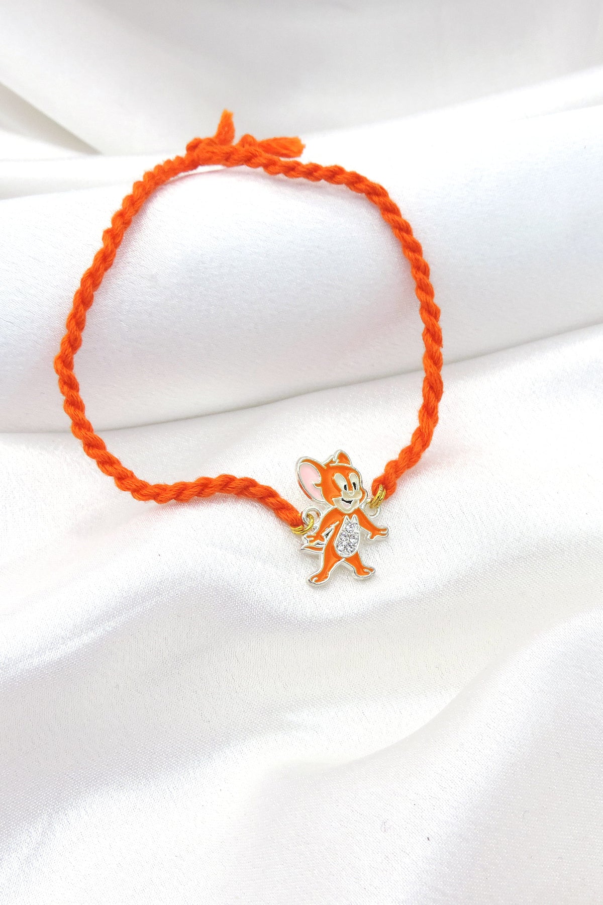 Jerry kids rakhi with orange enamel charm and CZ detailing by Joyrias