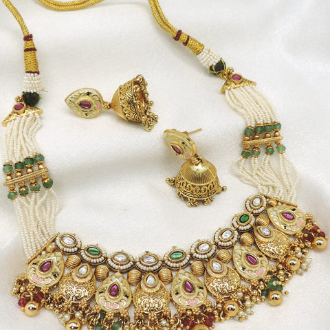 Rajwadi kundan meenakari choker necklace set with green and maroon detailing, pearl strands and matching jhumka earrings by joyrias