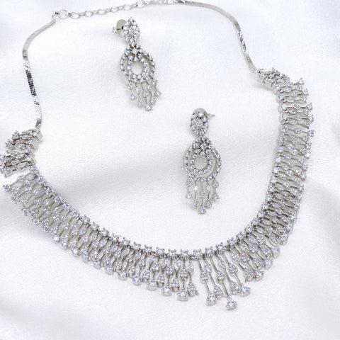 Silver CZ layered necklace set with matching dangling earrings by joyrias