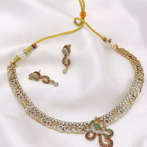 Gold-toned peacock CZ necklace set with green and maroon detailing and matching earrings by joyrias