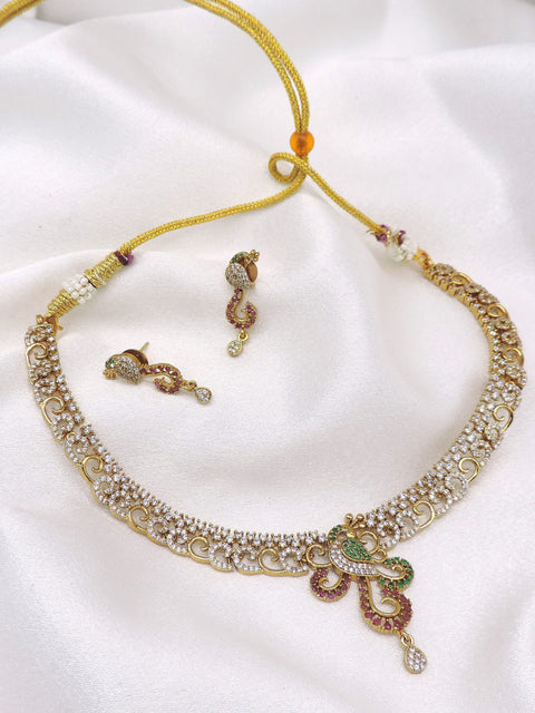 Gold-toned peacock CZ necklace set with green and maroon detailing and matching earrings by joyrias