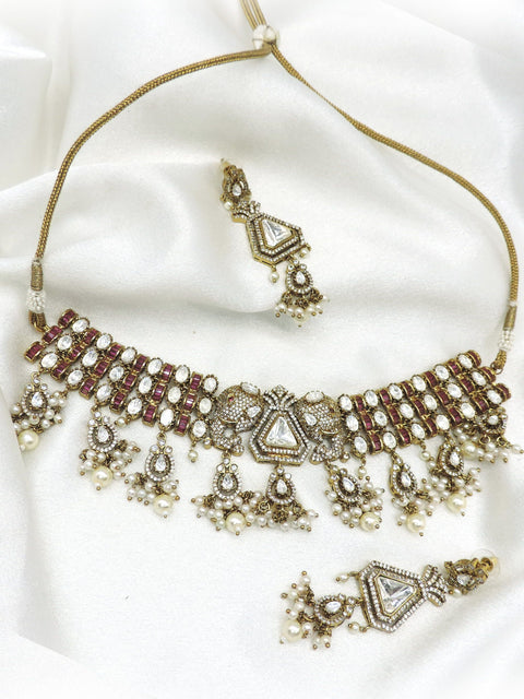Traditional polki kundan choker necklace set with maroon accents and pearl detailing by joyrias