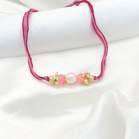 Pearl pink bead bhaiya rakhi with freshwater pearl and seed pearl clusters by Joyrias