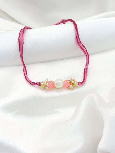 Pearl pink bead bhaiya rakhi with freshwater pearl and seed pearl clusters by Joyrias