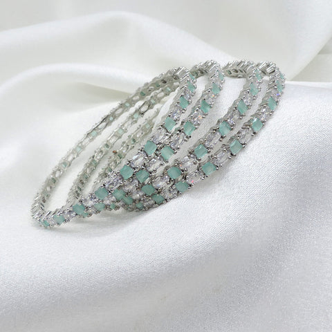 Exquisite silver-toned aqua stone AD bangle set with sparkling detailing by joyrias