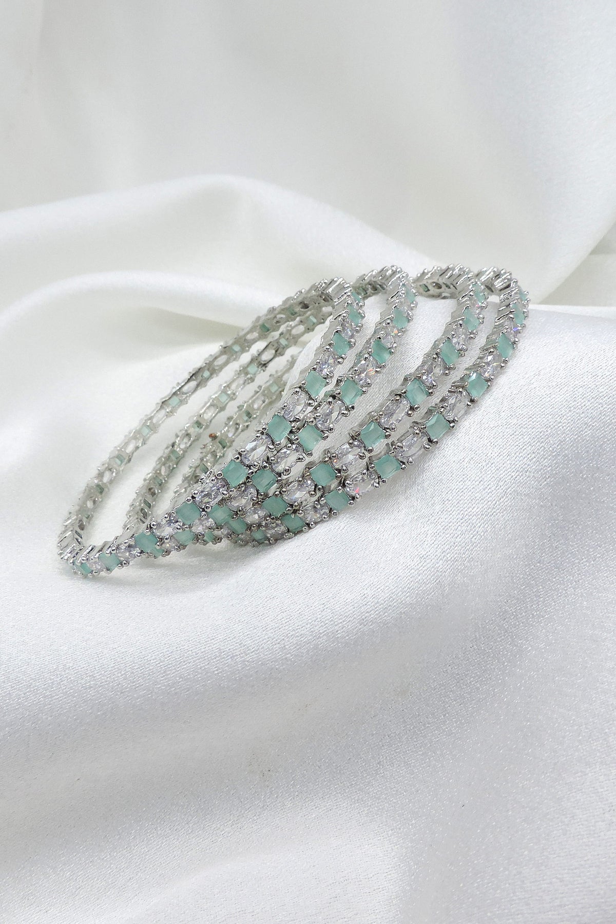 Exquisite silver-toned aqua stone AD bangle set with sparkling detailing by joyrias