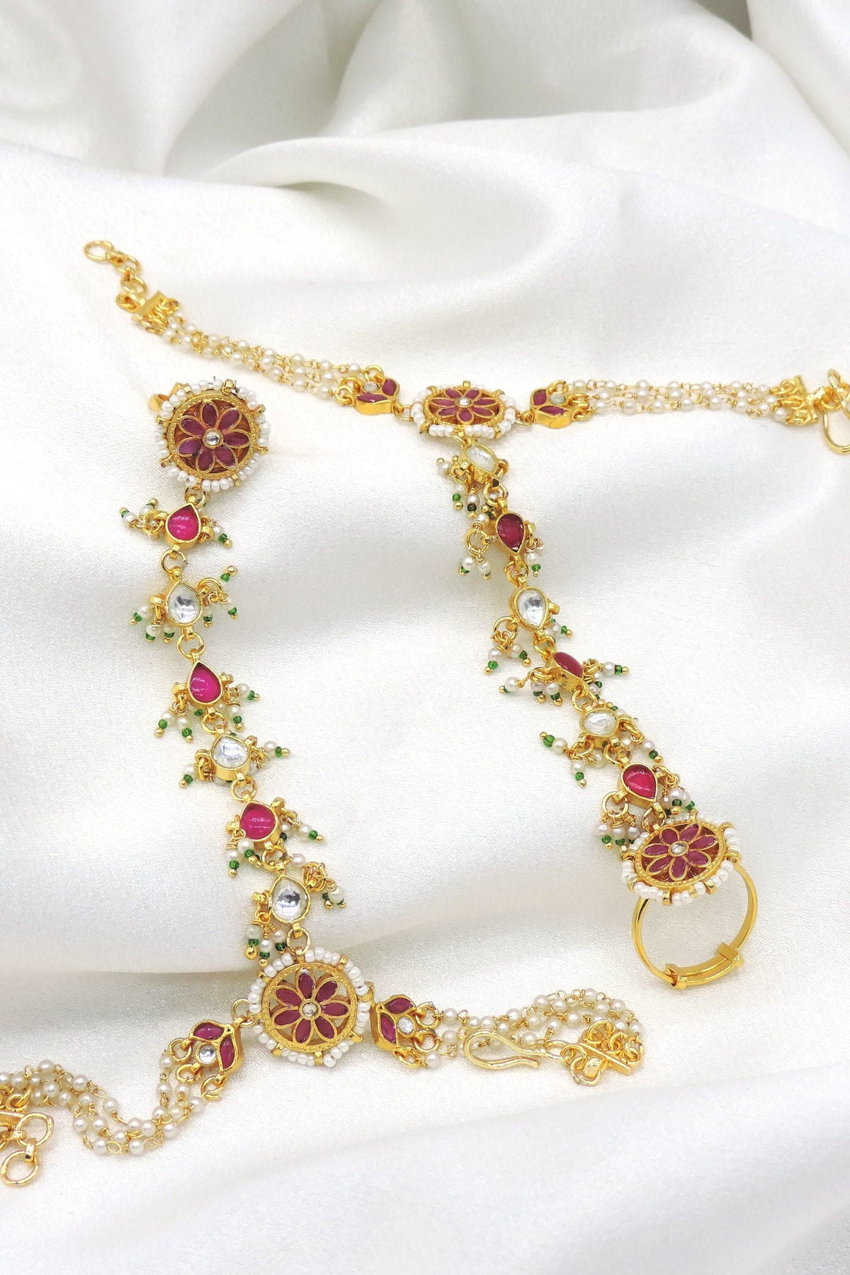 Maroon pearl kundan hathphool with floral detailing and hand chain from joyrias