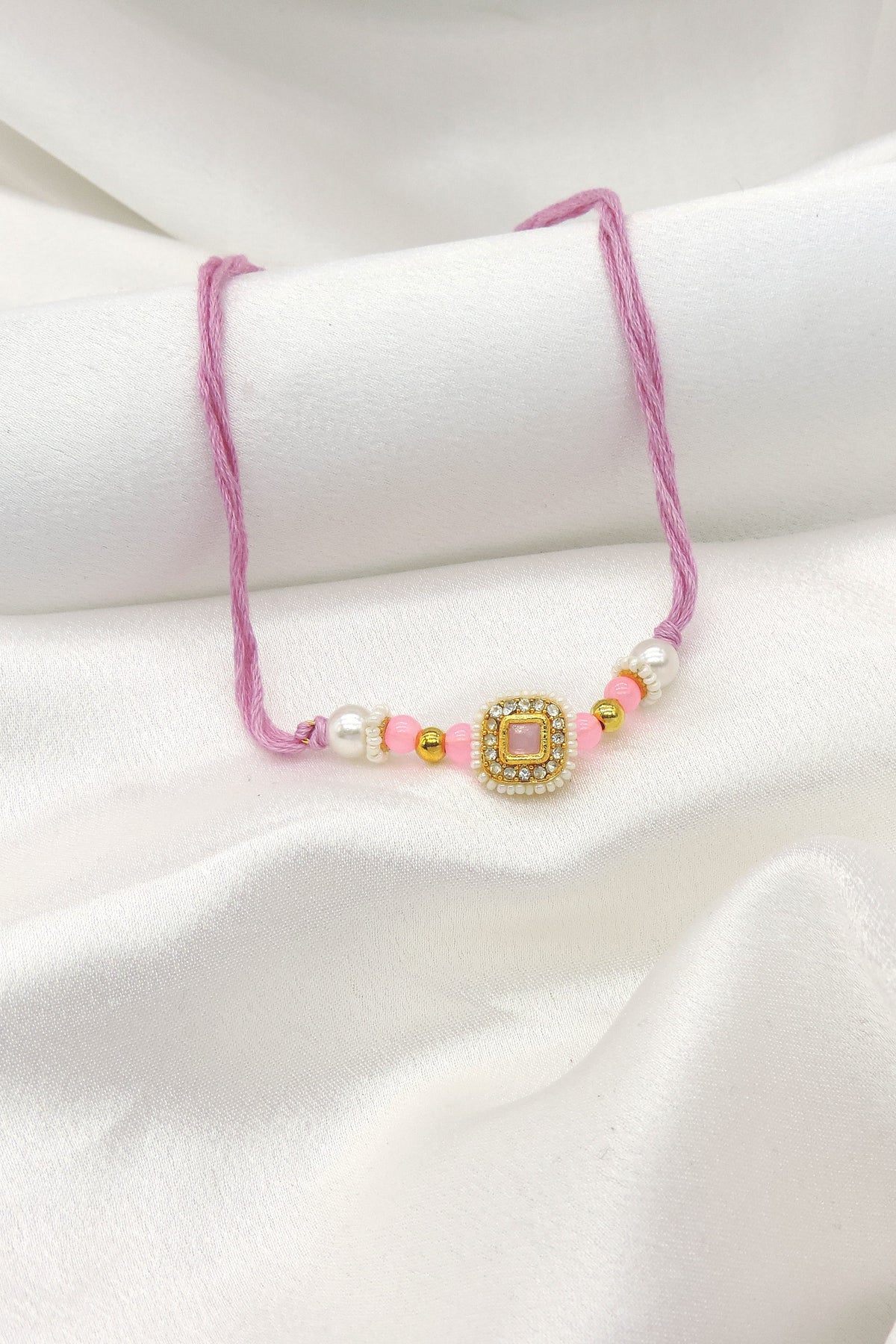 Pink square CZ pearl bhaiya rakhi by Joyrias