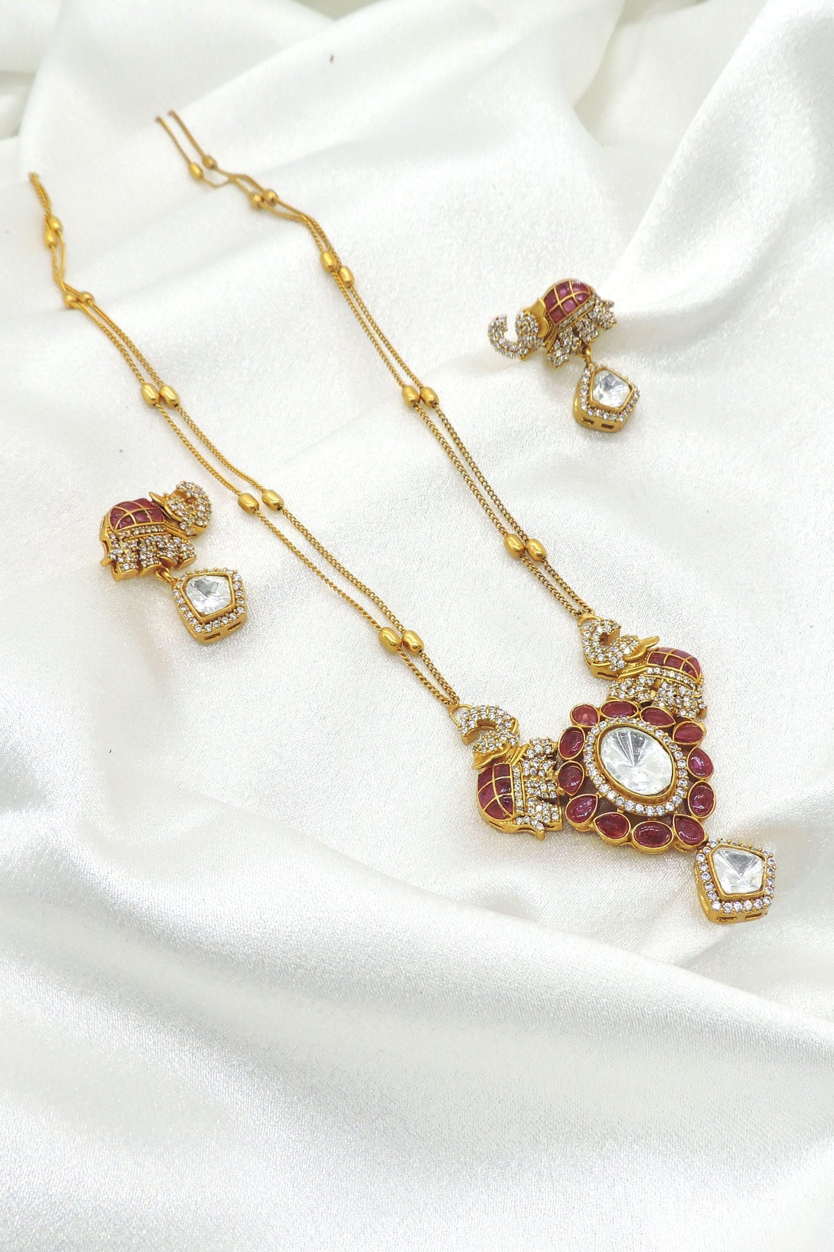 Majestic elephant motif necklace set with red and clear stones and matching earrings
