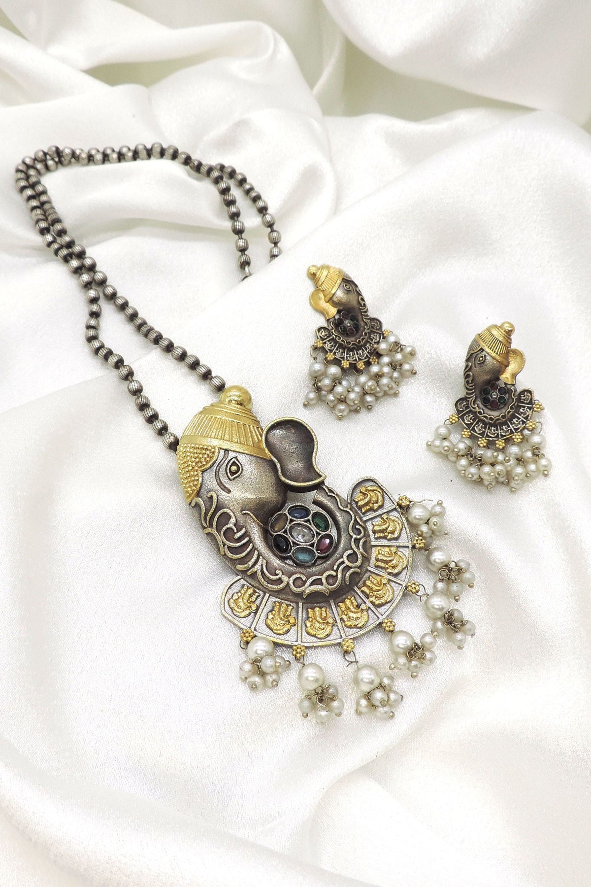 Ganesha motif imitation necklace set with accent stones, pearl clusters, CZ accents, and matching earrings